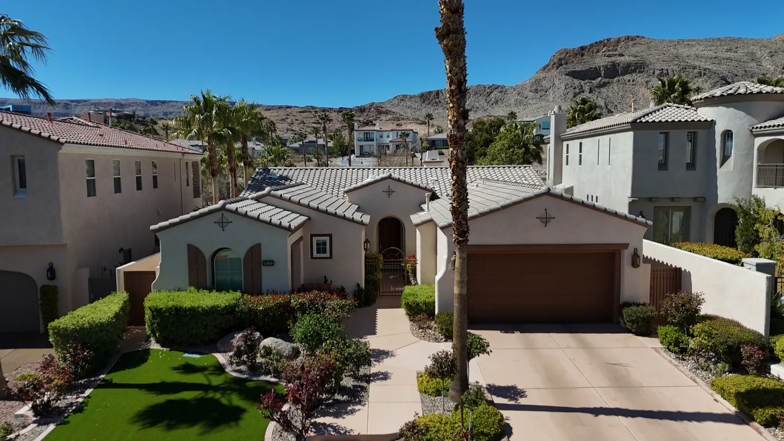 Aerial drone closeup of homes near Red Rock Canyon in Summerlin with mountain views