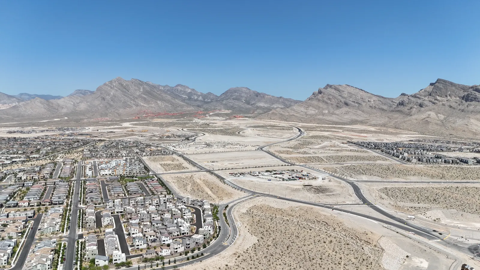 Aerial view of Summerlin Parkway and neighborhoods with mountains in the background