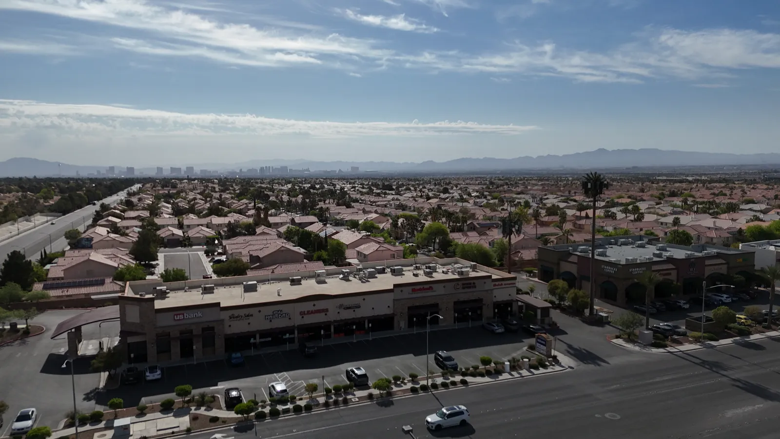 Aerial drone view of a Summerlin neighborhood with homes and tree-lined streets